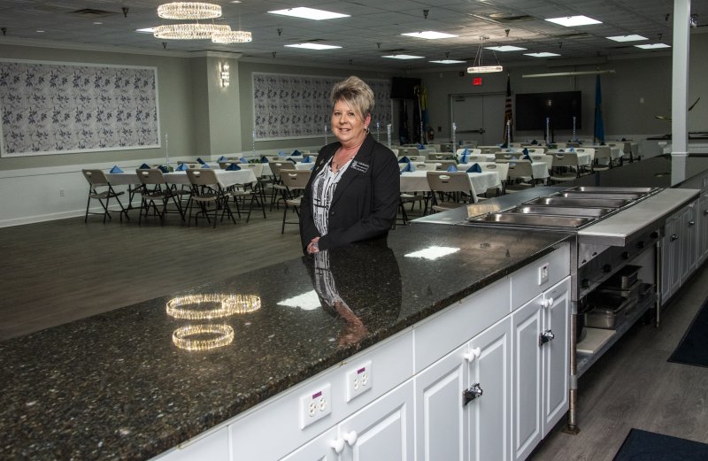 Bar Manager and Event Coordinator Lisa Schumann stands in the completed event space.